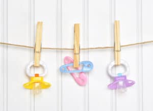 picture of baby pacifiers hanging from a string for decoration