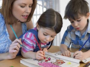 stay at home mom helping children color