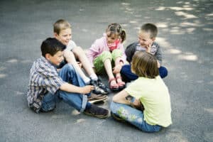 picture of a group of kids hanging out together outside in the summer