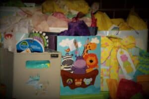 picture of a lot of baby shower gift bags with tissue paper