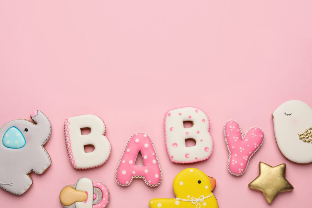 picture of decorated sugar cookies that spell BABY in the center of baby shower gifts