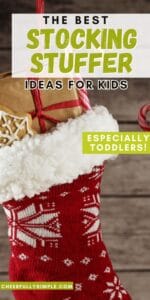 Pinterest pin with the text, "The Best Stocking Stuffer Ideas for Kids- Especially Toddlers", and a picture of a Christmas stocking hanging on a wall filled with stocking stuffer gifts