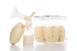 breast pump with bags full of breastmilk