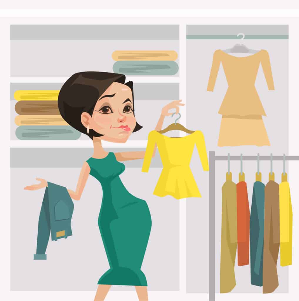 postpartum woman looking at clothes trying to figure out what to wear after giving birth