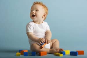 picture of a baby playing with blocks at daycare