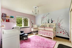 picture of a baby's nursery with various pieces of nursery furniture and decor