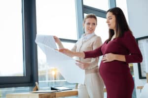 picture of a busy pregnant woman at work