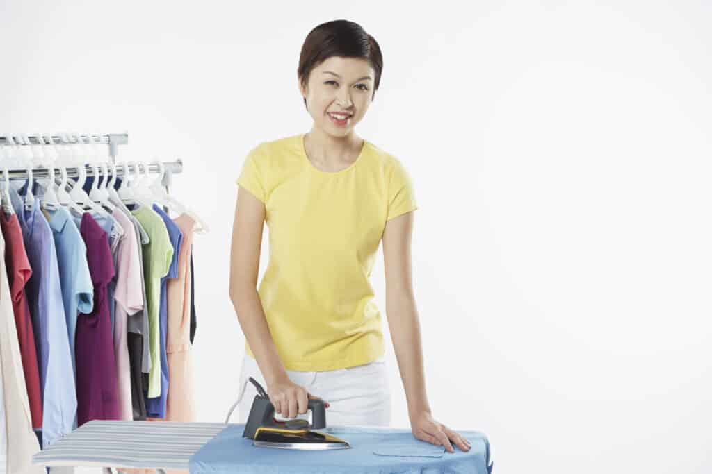 woman hanging clothes on hangers