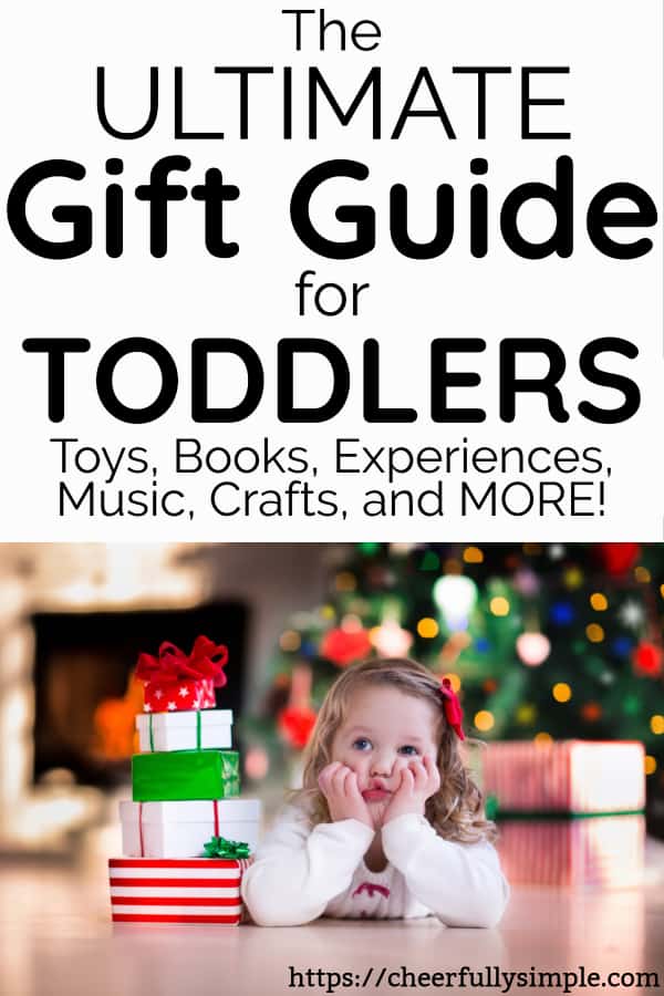 toddler Christmas gift guide with toddler waiting to open Christmas gifts