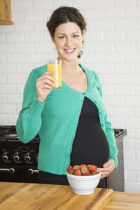 pregnant woman drinking orange juice