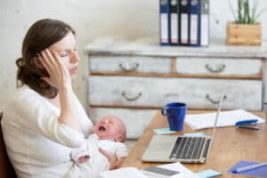 picture of a sleep deprived mother with screaming infant