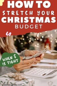 Pinterest pin with the text, "How to stretch your frugal Christmas budget, when money is tight" with a picture of a woman sitting at Christmas working on the Christmas budget while counting money
