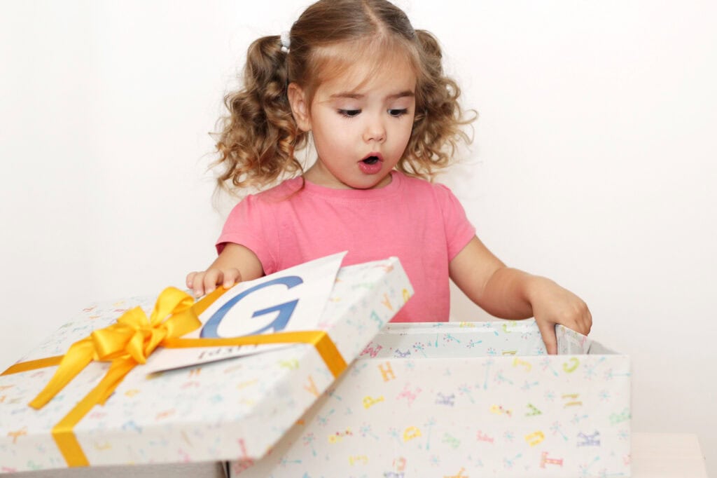 toddler girl with a birthday gift