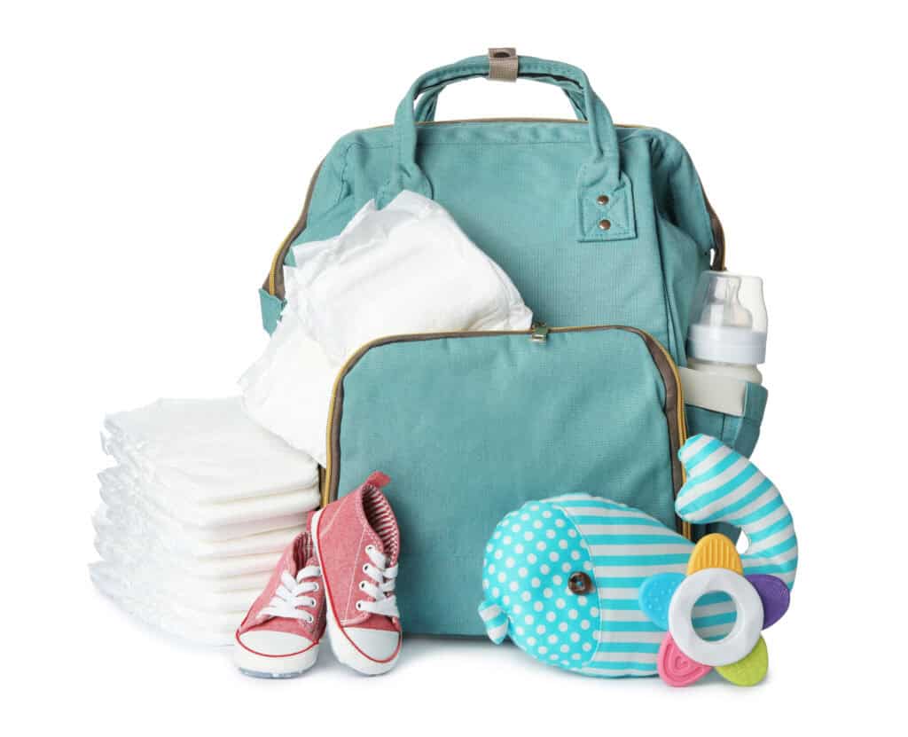 baby diaper bag for 2 kids with baby diaper, baby shoes, baby toys, and a baby bottle