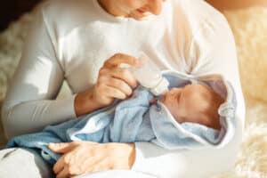 father feeding his breastfed baby a bottle pinterest pin