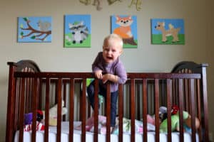 crying toddler trying to get out of the crib