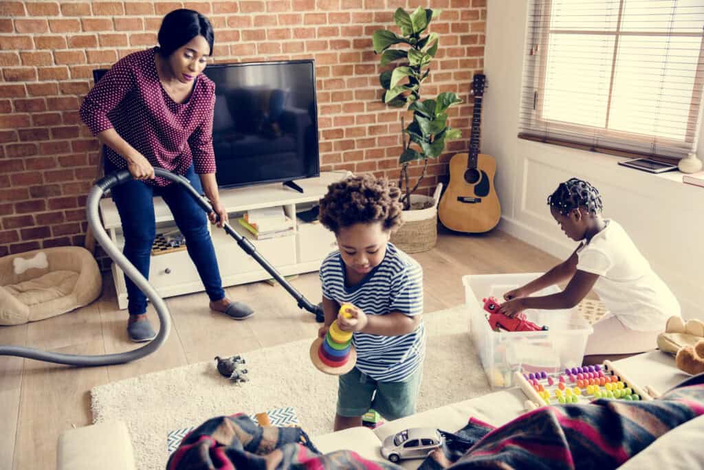 picture of a family cleaning the living room as part of their stay at home mom routine