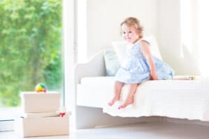 toddler girl in a toddler bed