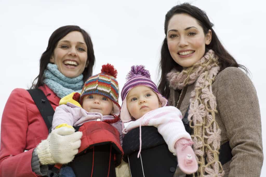 moms wearing babies in baby carriers