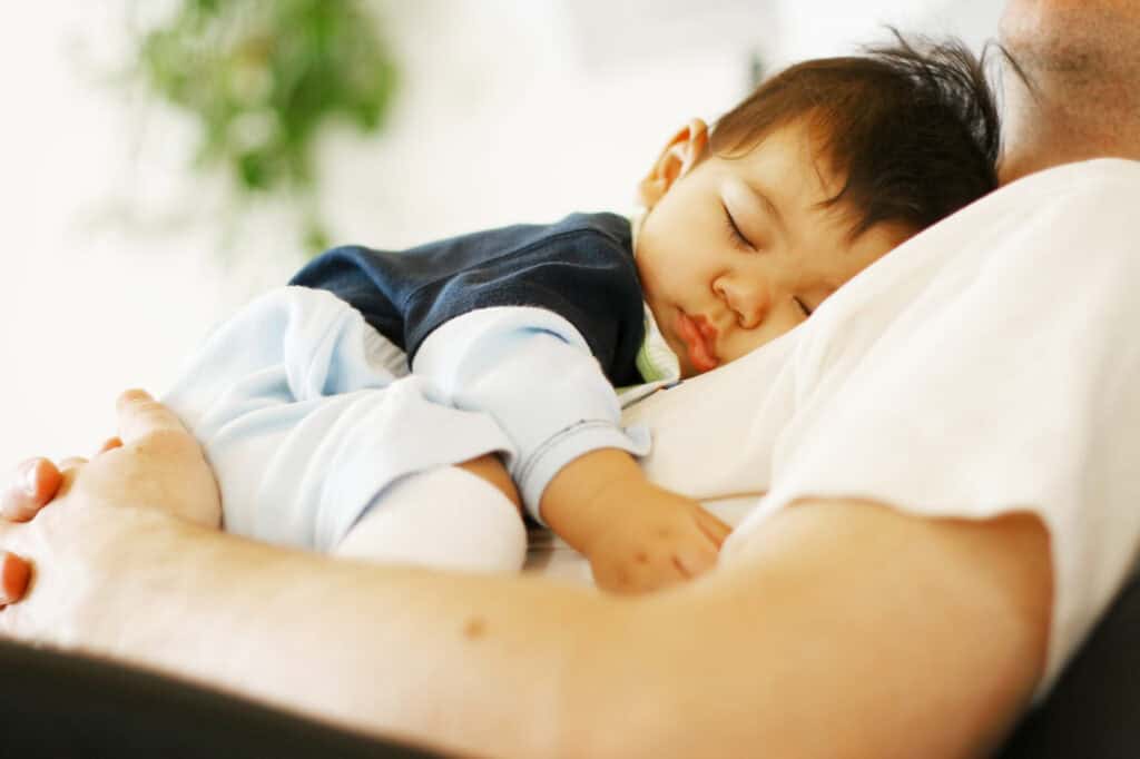 new dad holding a sleeping baby