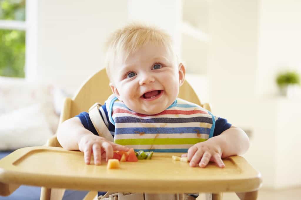 picture of baby sitting in high chair for baby-led weaning