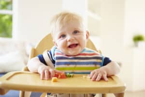 picture of baby sitting in high chair for baby-led weaning