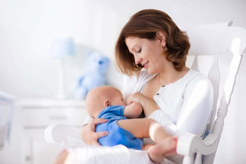 woman breastfeeding wearing a nursing friendly dress