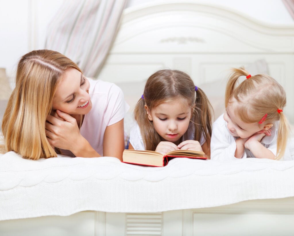 children reading the Bible with their mother