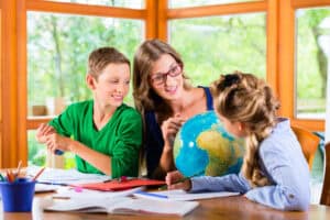 homeschool mom working with kids on a Christian homeschool curriculum
