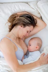 mother breastfeeding in side-lying position