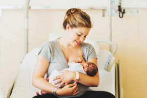 picture of a woman in the hospital using the cradle position while breastfeeding