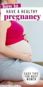 how to have a healthy pregnancy Pinterest pin with a picture of a pregnant woman sitting on the floor with her arms wrapped around her pregnant belly