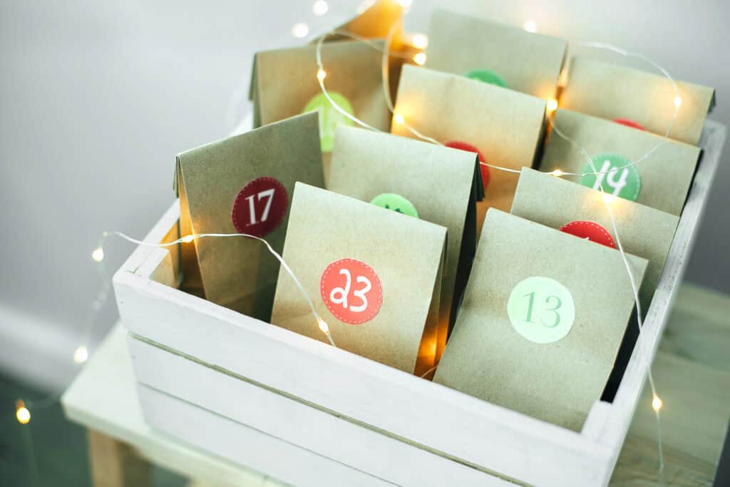 picture of a basket of Christmas themed paper bags with numbers for an Advent calendar