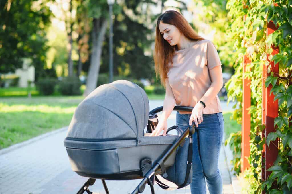 picture of a new Mom walking with her baby in a stroller