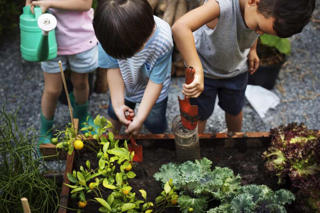kids outside planting a spring garden